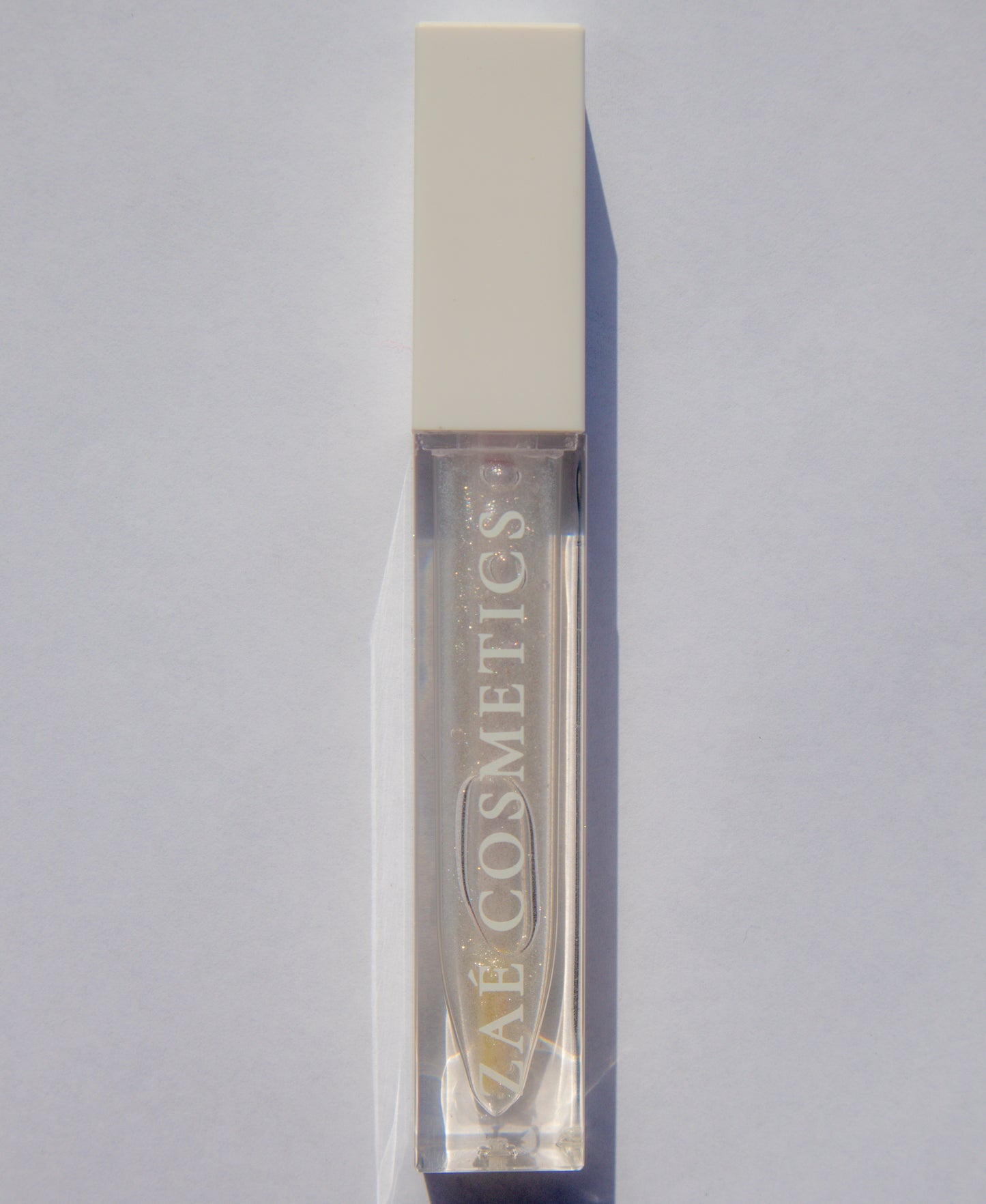 Zaé shimmer lip gloss vegan sparkle"
"Zaé shimmer gloss cruelty-free glossy finish"
"Zaé shimmer lip gloss swatches shimmering"
"Zaé shimmer gloss packaging Zaè Cosmetics