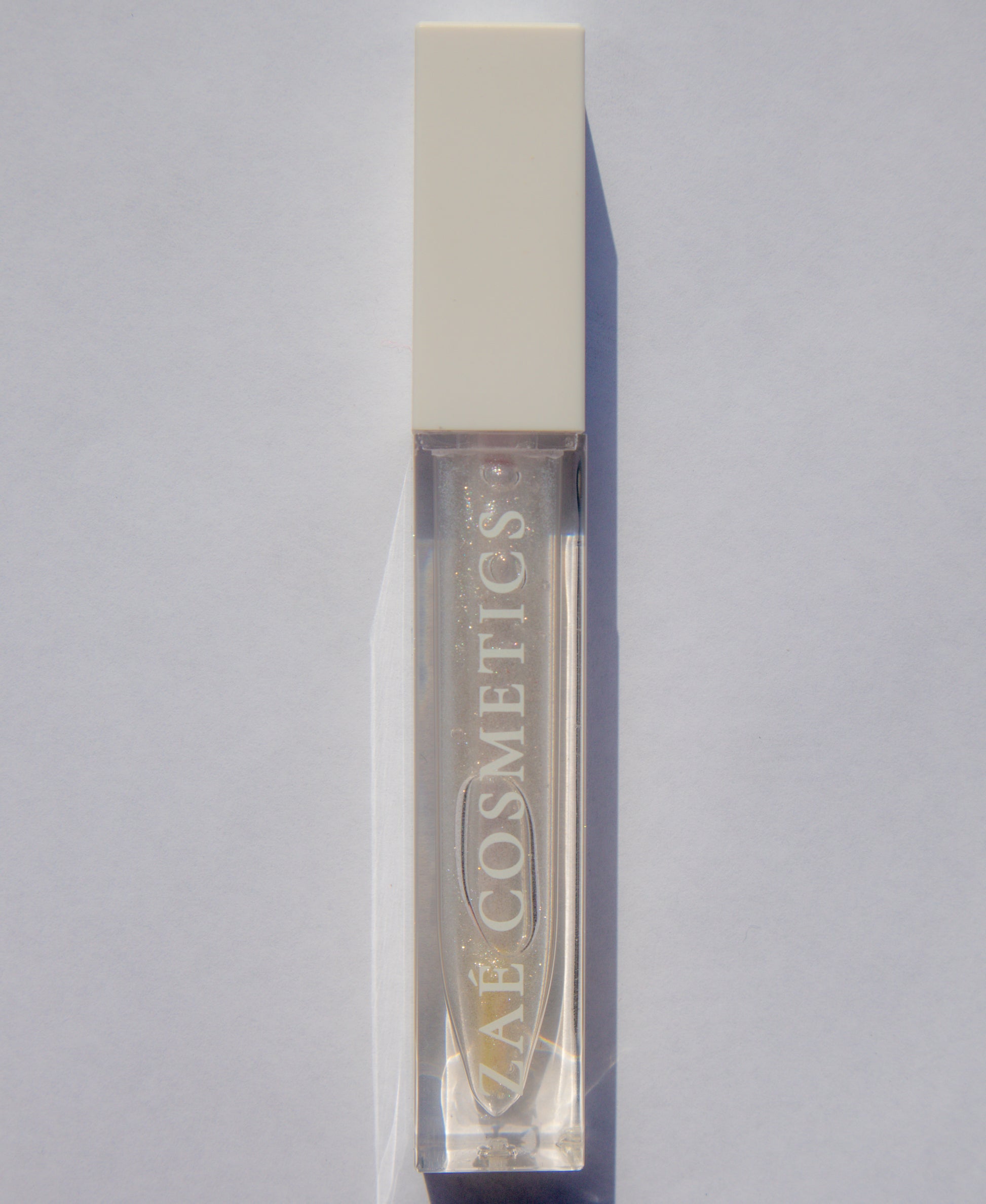 Zaé shimmer lip gloss vegan sparkle"
"Zaé shimmer gloss cruelty-free glossy finish"
"Zaé shimmer lip gloss swatches shimmering"
"Zaé shimmer gloss packaging Zaè Cosmetics